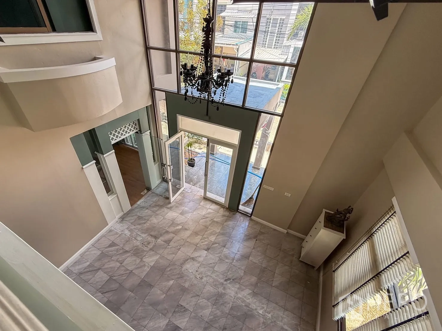 Home Office for rent in Wang Thonglang, Bangkok - View from mezzanine over tall-windowed foyer with chandelier.