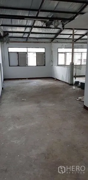 Home Office for rent or sale in Bang Na, Bangkok - Semi-enclosed rooftop or storage area with concrete floor and metal roof.