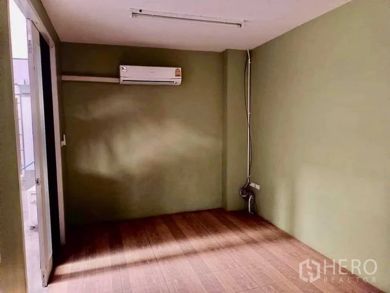 Warehouse for rent in Samut Prakan - Compact private office with air-conditioner and wood-look flooring.