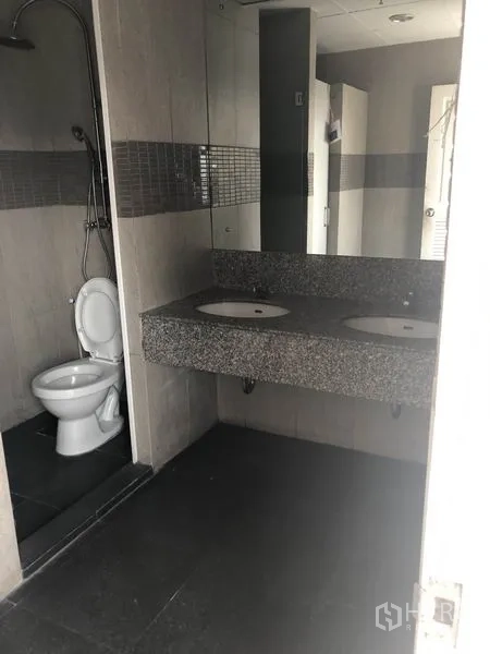 Office Space for rent in Watthana, Bangkok - Restroom vanity with double sinks and large mirror beside shower.