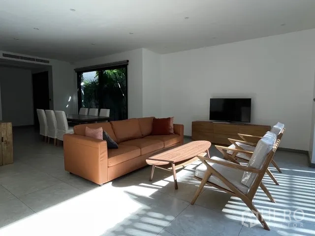 Detached House for rent in Watthana, Bangkok - Open-plan living room with sofa set, TV console, and dining space.