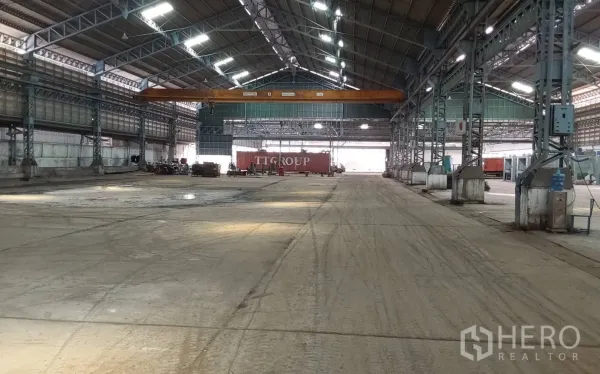 Factory for rent or sale in Bang Phli, Samut Prakan - Warehouse interior showing container loading area and gantry crane.