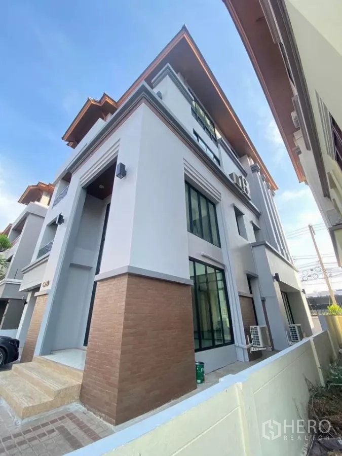 สำนักงานที่บ้าน ให้เช่าในWang Thonglang, Bangkok - มุมมองด้านข้างของอาคารหัวมุม หน้าต่างบานใหญ่และผนังลายอิฐ
