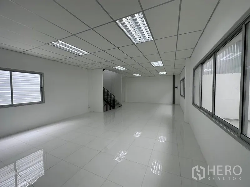 Factory for rent in Khlong Luang, Pathum Thani - Bright second‑floor office with large windows overlooking the warehouse floor