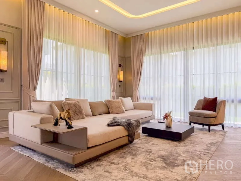 独立式住宅 出租或出售在Bang Kapi, Bangkok - 客厅大沙发、茶几与落地窗。