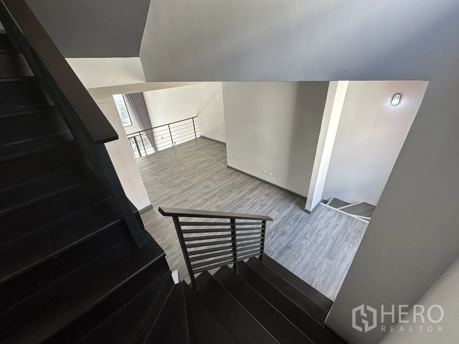 Home Office for rent or sale in Suan Luang, Bangkok - Staircase perspective overlooking an airy double-volume main hall.