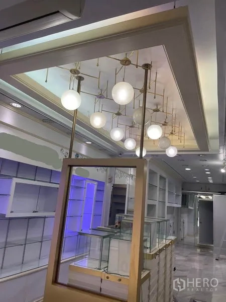 Shophouse for rent in Bang Rak, Bangkok - Close view of brass globe pendant lighting above the sales counter.