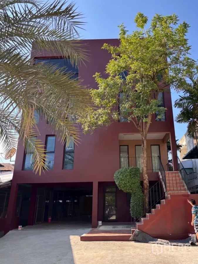 Home Office for rent in Phra Khanong, Bangkok - Three-storey maroon home office with external staircase, driveway parking and mature trees in Phra Khanong, Bangkok.