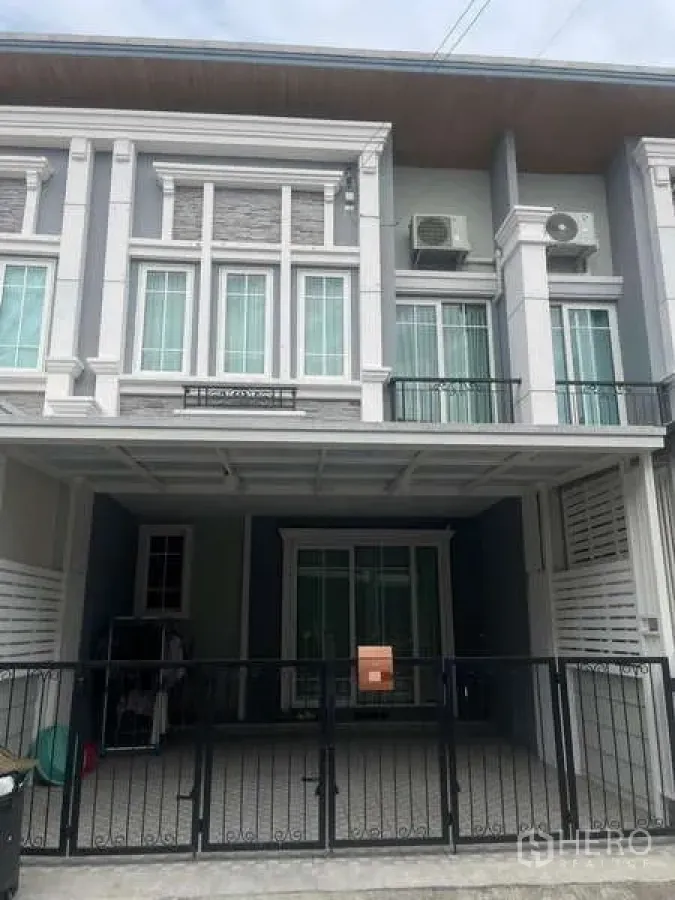 Townhouse for rent or sale - Modern two-storey townhouse facade with gated covered carport.