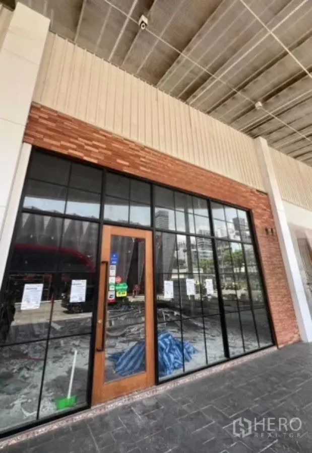 Retail Space for rent - Street-level retail unit with full-height glass storefront and brick facade in Ekkamai, Bangkok