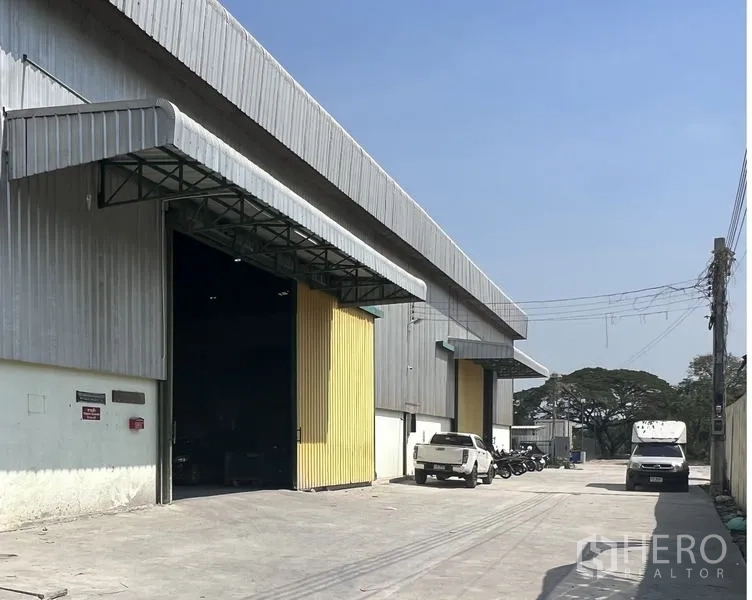 Warehouse for rent in Lat Krabang, Bangkok - Concrete driveway beside the warehouse with an open loading bay and space for trucks and motorbikes.