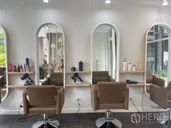 Retail Space for rent in Khlong Toei, Bangkok - Three salon stations with arched mirrors, shelving and brown chairs.