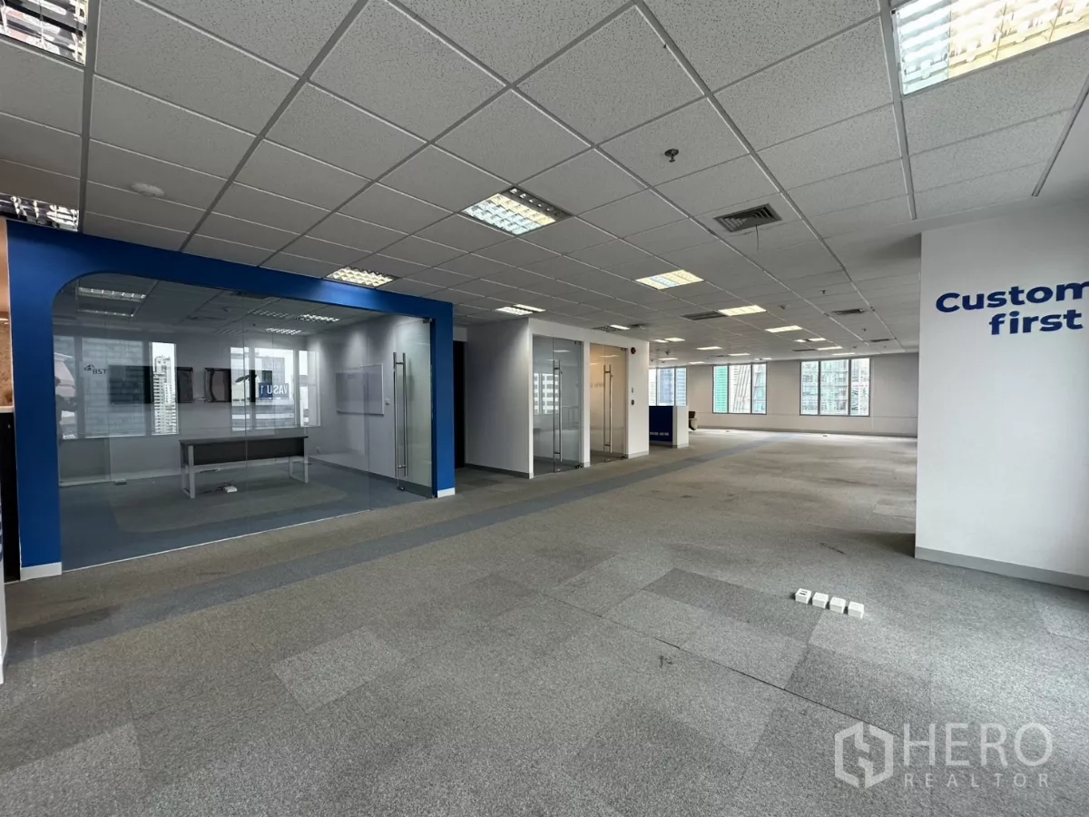 Office Space for rent in Watthana, Bangkok - Flexible office floor with multiple glass conference rooms and grey carpet.