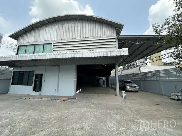 货栈 出租在Pak Kret, Nonthaburi - 金属外墙仓库立面，带雨棚装卸区与停车位