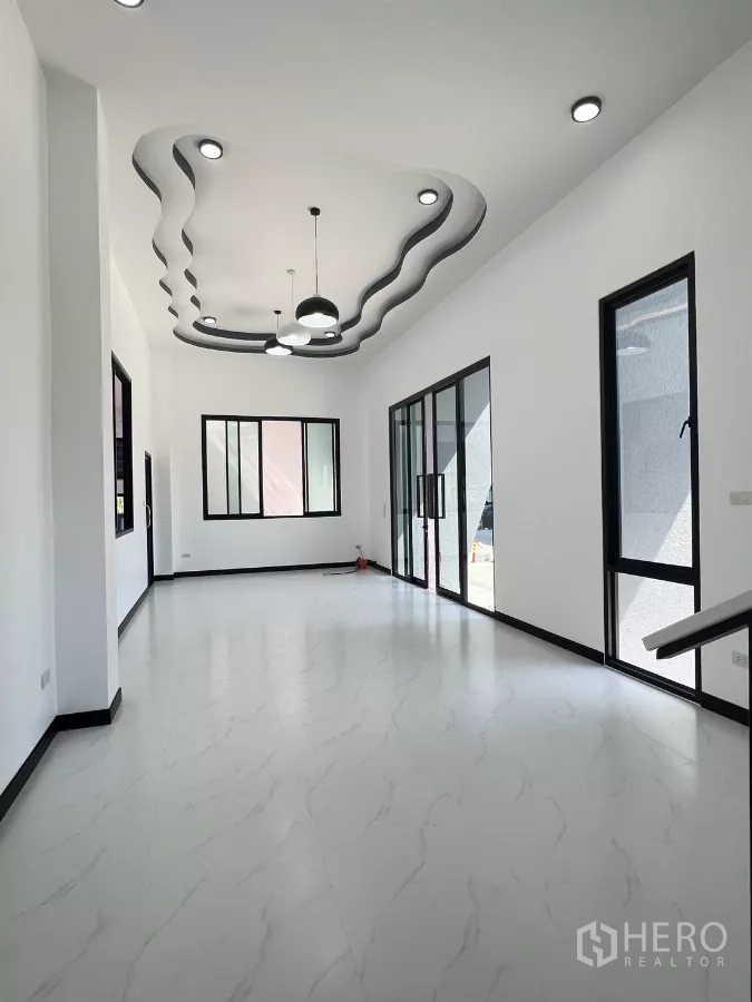 Warehouse for sale in Lam Luk Ka, Pathum Thani - Light-filled office room with wavy feature ceiling, sliding glass doors and tile floors.