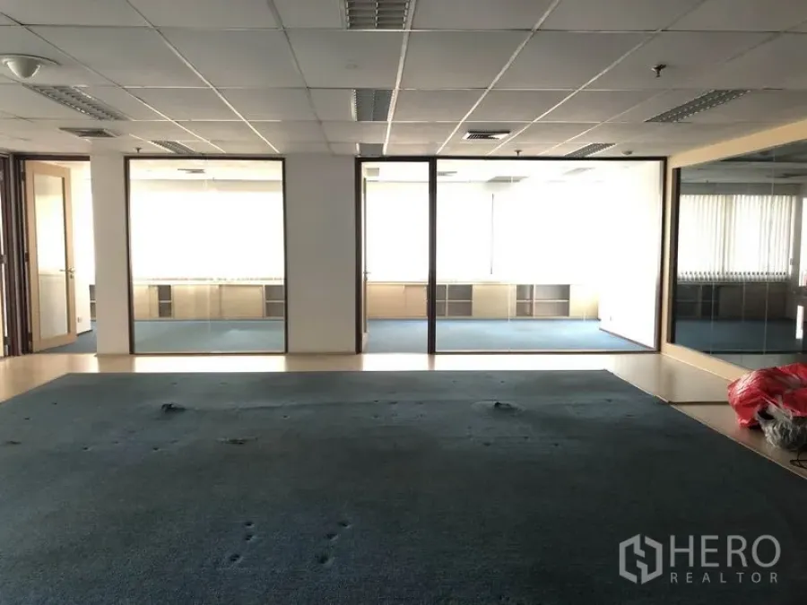 Office Space for rent in Watthana, Bangkok - Wide view of open-plan area and three glass-fronted offices with window blinds.