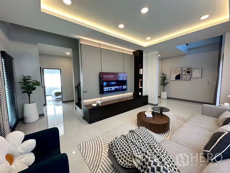 Detached House for rent in Bang Phli, Samut Prakan - Living room view showing long media cabinet and access to staircase.