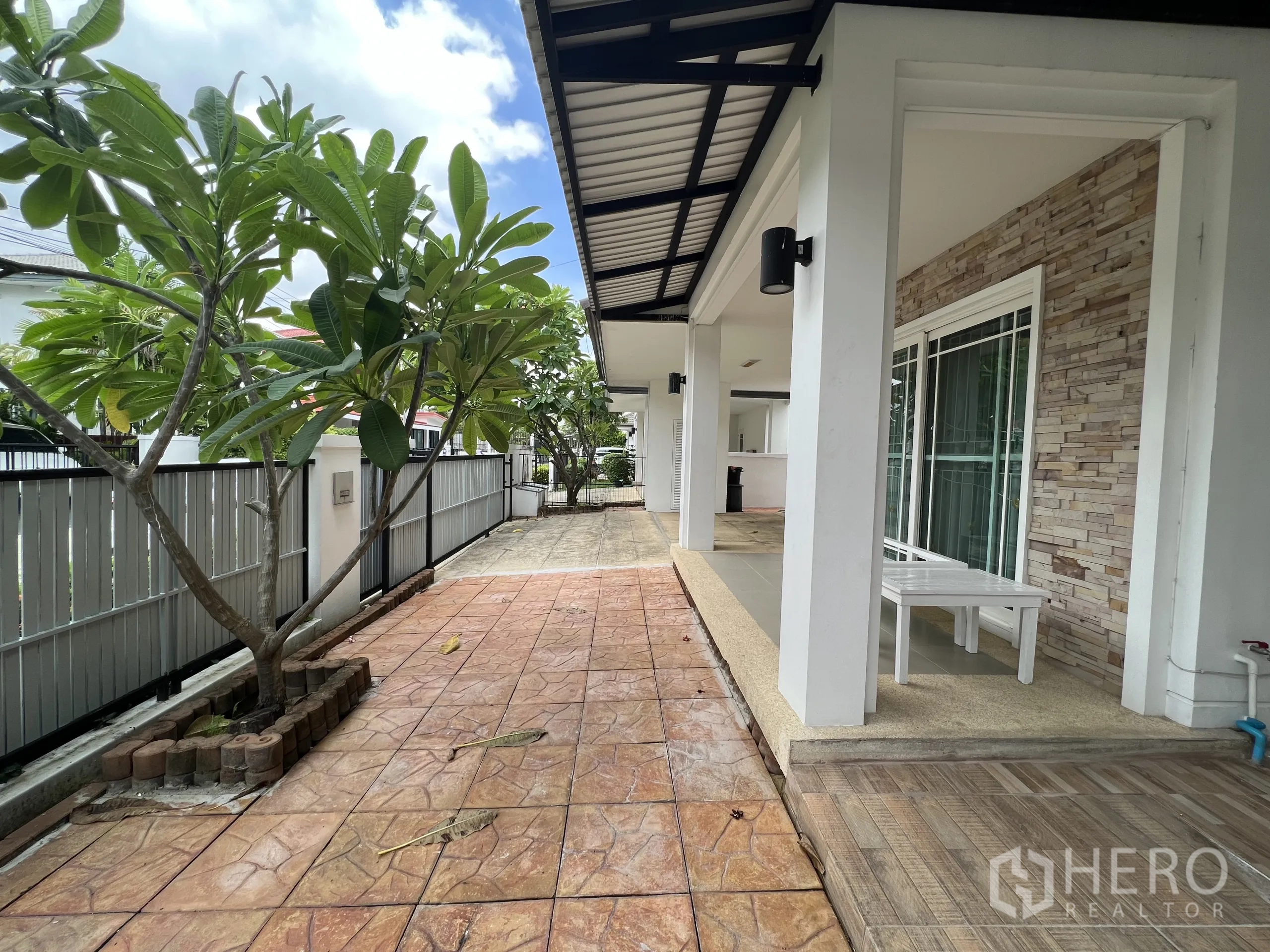 Detached House for rent in Bang Kapi, Bangkok - Wraparound terrace with trees and sliding glass doors opening to the porch.