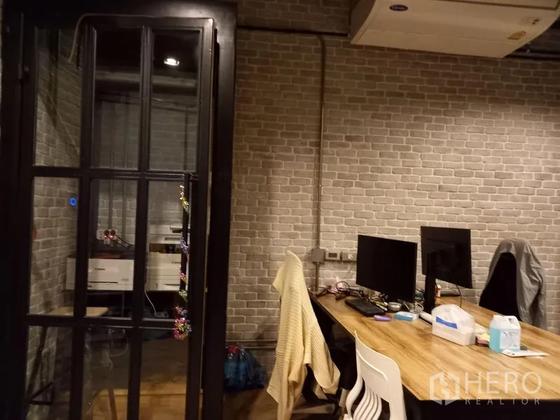 Office Space for rent in Chatuchak, Bangkok - Workstations beside a black-framed door and split-type air conditioning.