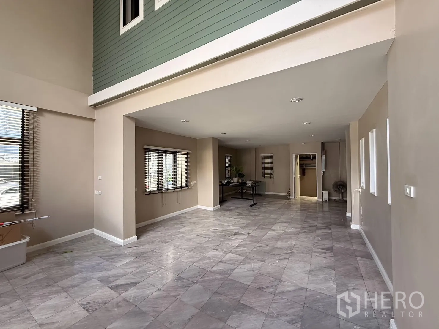 Home Office for rent in Wang Thonglang, Bangkok - Open-plan reception area with large windows and marble flooring.