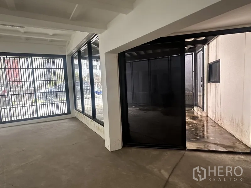 Home Office for rent or sale in Bang Na, Bangkok - Open-plan room looking toward a covered patio through sliding glass doors.
