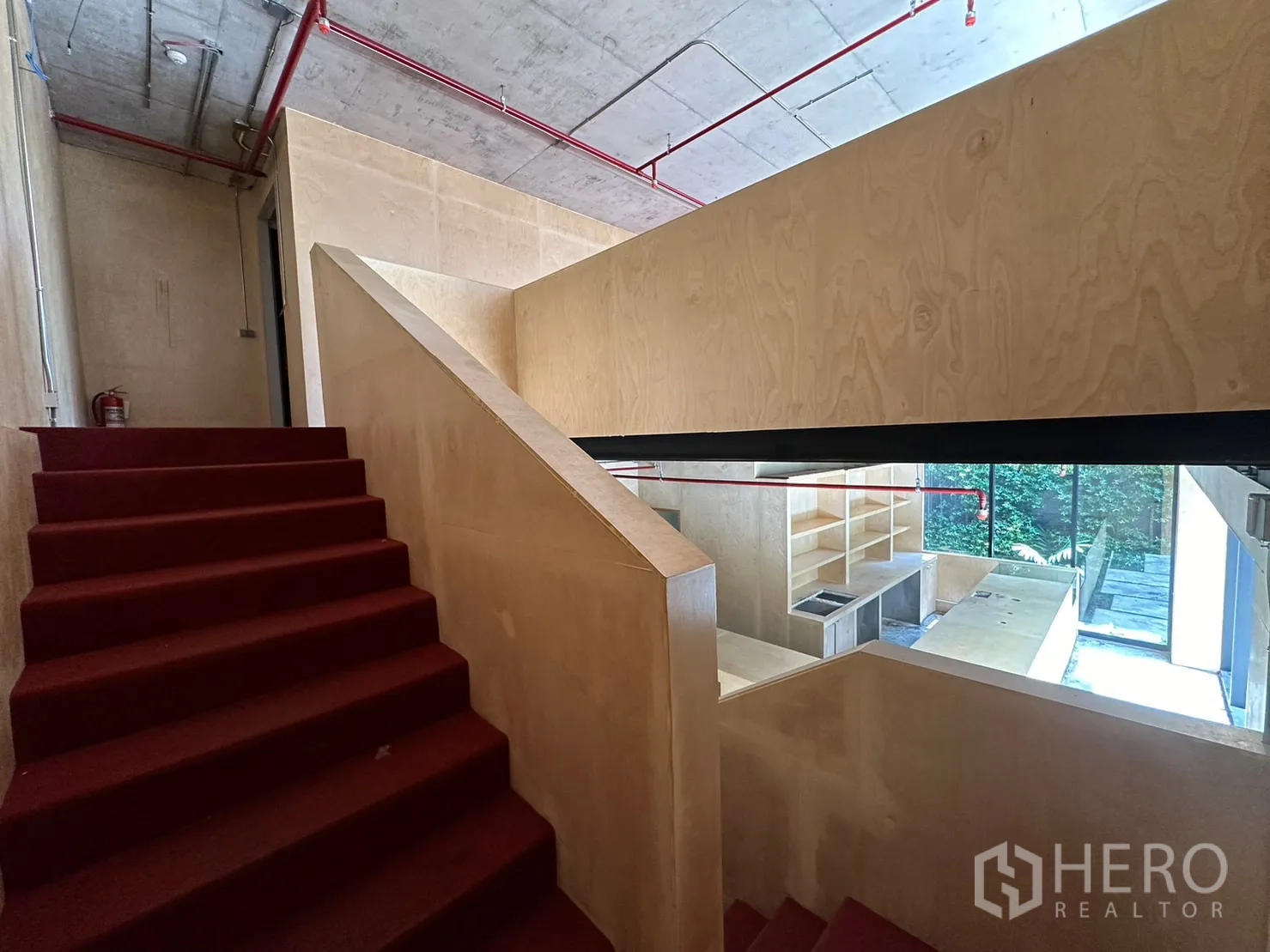 Retail Space for rent in Watthana, Bangkok - Carpeted staircase with plywood balustrade overlooking bar and windows below.