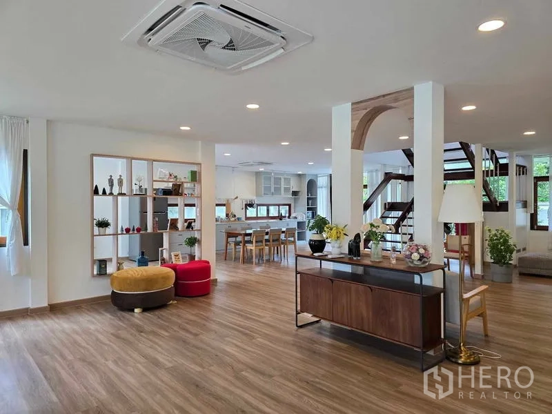 Home Office for rent - Open-plan lounge with display shelving, dining area and a staircase to the upper floor.