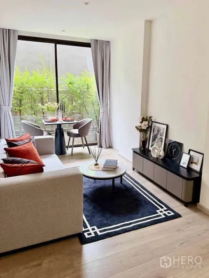 Condominium for rent - Living room toward the window with dining set, TV console and decorative pieces.