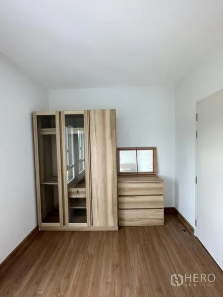 Townhouse for rent in Bang Phli, Samut Prakan - Third bedroom or study with light wood wardrobe and dresser.