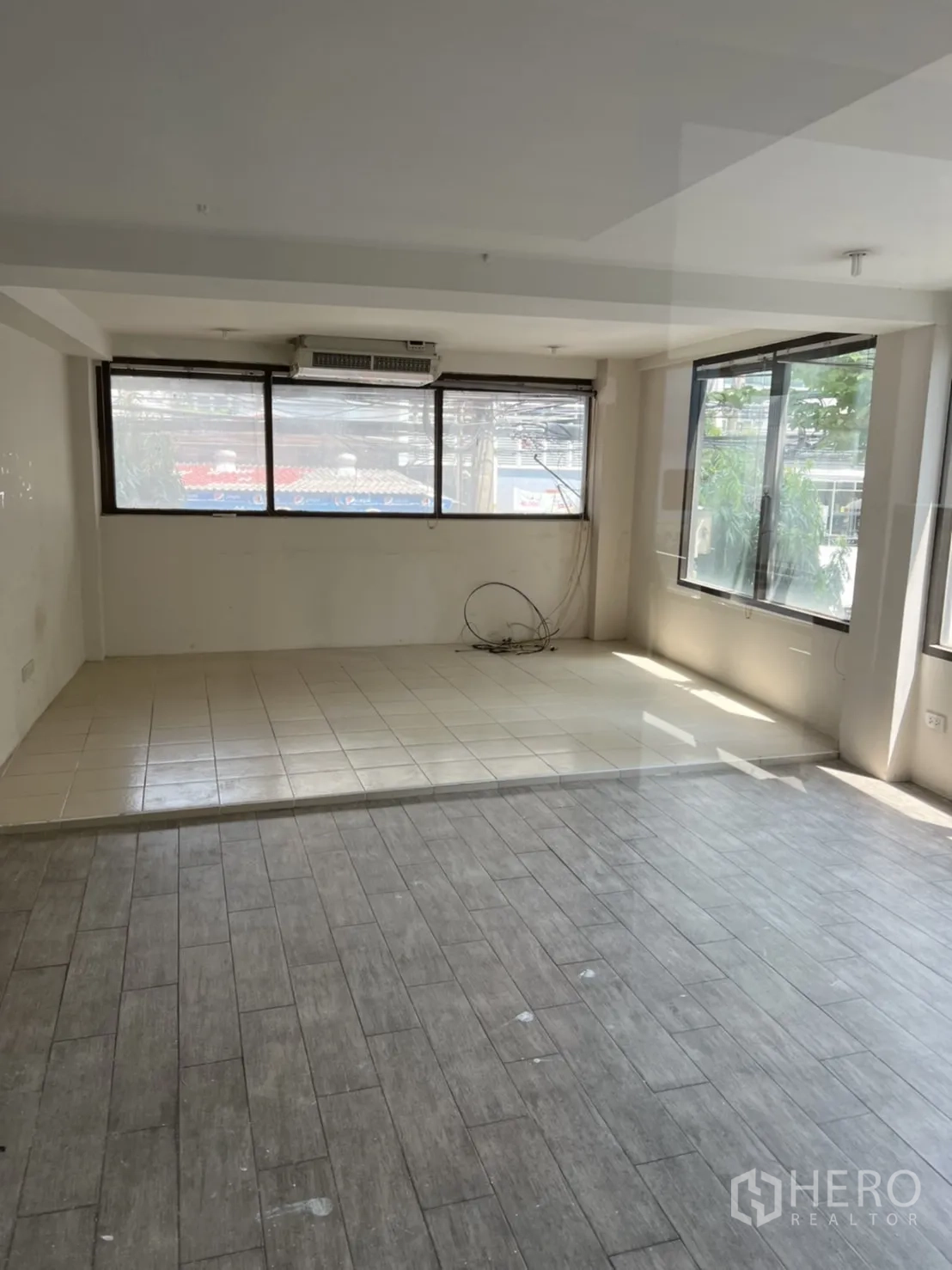 Retail Space for rent in Watthana, Bangkok - Bright upper room with mixed tile and wood-look flooring, large windows, and air conditioning.