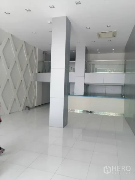Retail Space for rent in Watthana, Bangkok - Bright double-height lobby with white tiles, columns and a mezzanine railing.