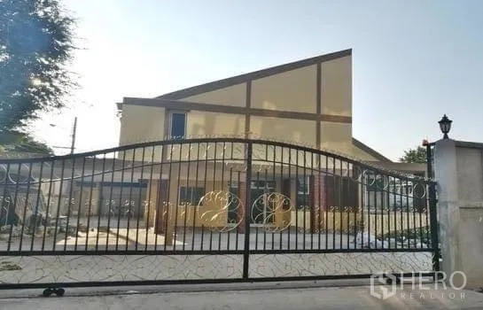 Office Space for rent in Chatuchak, Bangkok - Gated property exterior with wide driveway and modern angular facade suitable for offices.