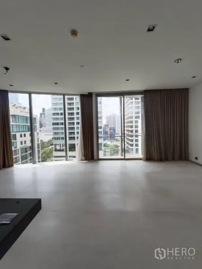 Condominium for rent or sale in Bang Rak, Bangkok - Bright living area with floor-to-ceiling windows, balcony access and Bangkok city views.