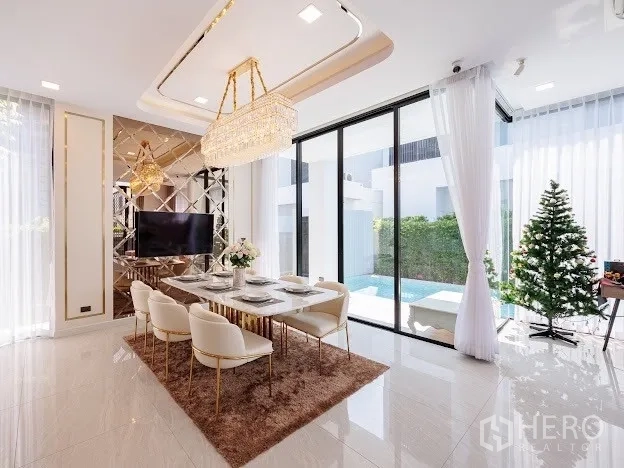 Detached House for sale in Prawet, Bangkok - Bright dining room with crystal chandelier, six-seat table, and sliding doors to pool.