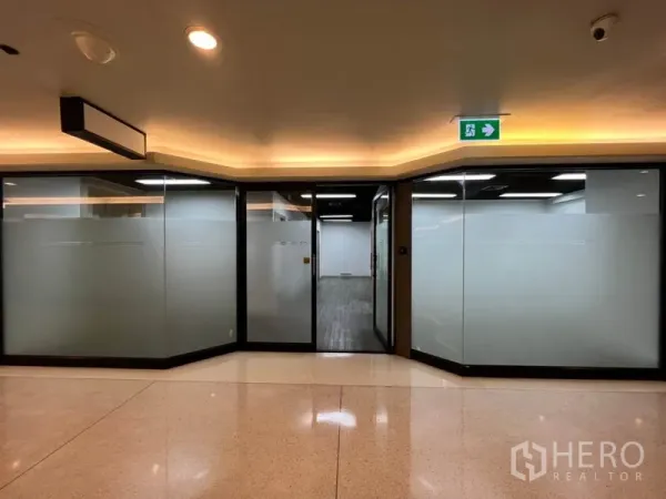 Office Space for rent in Khlong Toei, Bangkok - Exterior of office unit with wide frosted glass frontage and sliding door from building hallway.