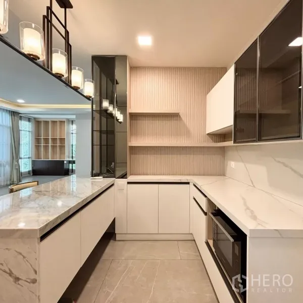 Detached House for rent or sale in Prawet, Bangkok - Designer pantry kitchen with marble countertops, white cabinetry and feature lighting.