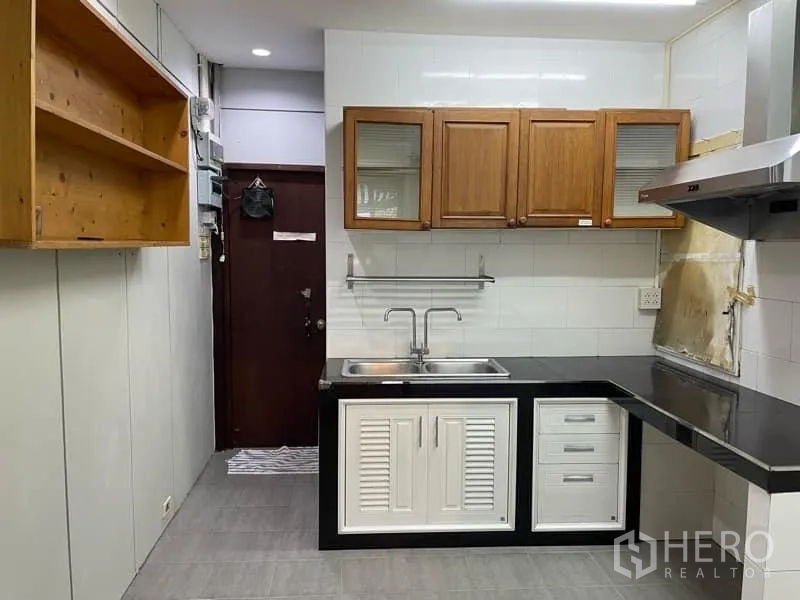Retail Space for rent in Watthana, Bangkok - Galley pantry featuring double sink, range hood, tile floor and upper wooden cabinets.