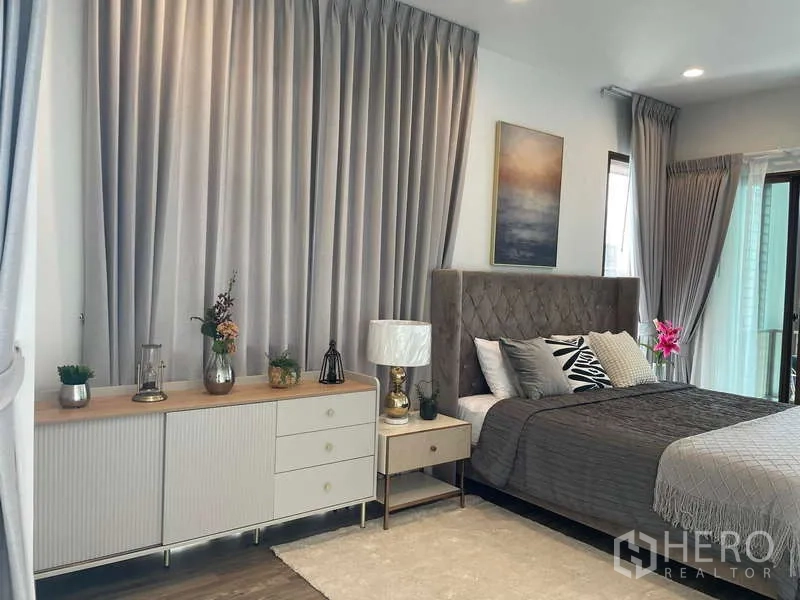 Detached House for rent in Bang Kapi, Bangkok - Master bedroom detail with sideboard, bedside lamps and soft grey drapes.