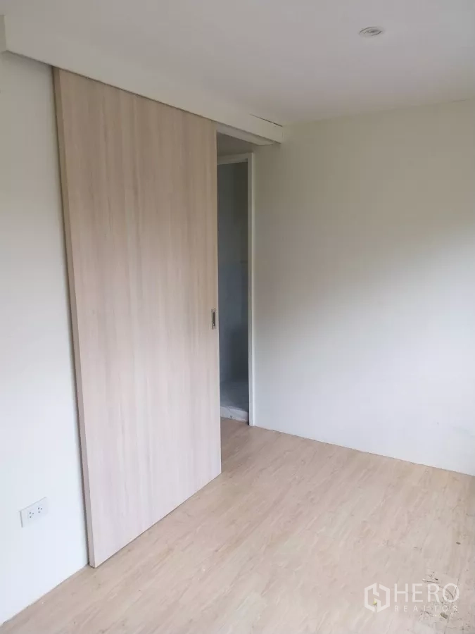 Retail Space for rent - Private room with light wood sliding door and laminate flooring.
