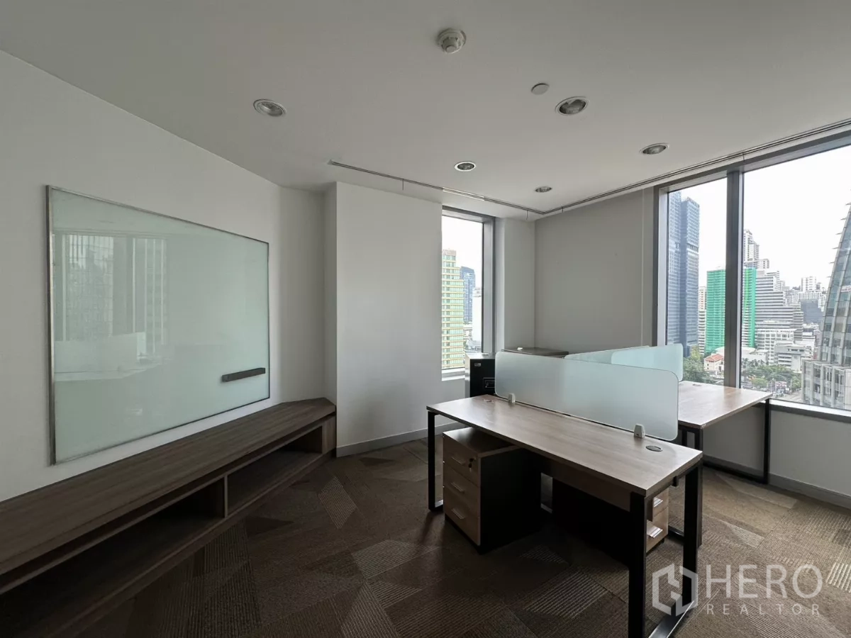 Office Space for rent in Watthana, Bangkok - Corner office with two desks, panoramic windows and skyline views.