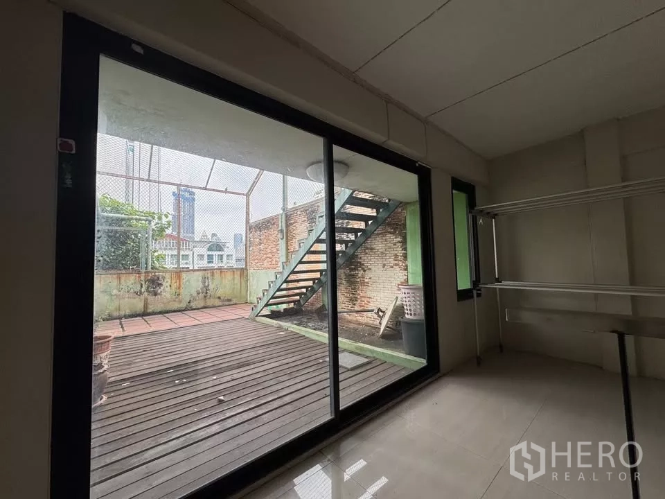 Shophouse for rent in Bang Rak, Bangkok - Sliding glass doors opening to a decked terrace with exterior staircase.
