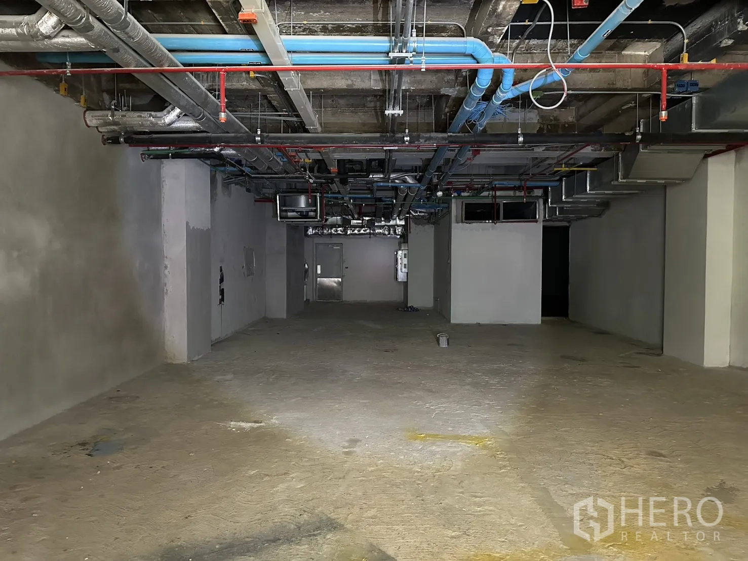 Retail Space for rent in Bang Rak, Bangkok - Deep rectangular space with high ceiling and visible MEP installations.
