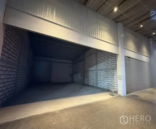 Retail Space for rent - Wide shop bay with high ceiling under covered arcade, unfinished brick walls ready for fit-out