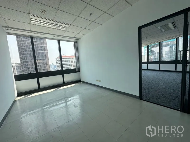 Office Space for rent in Khlong Toei, Bangkok - Private office with window connected to a carpeted area through a glass door.