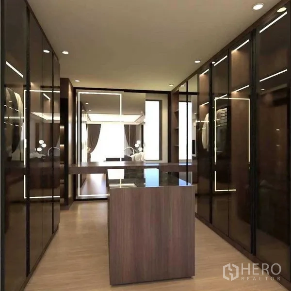 Townhouse for sale in Suan Luang, Bangkok - Walk-in wardrobe corridor with mirrored doors and a center island.
