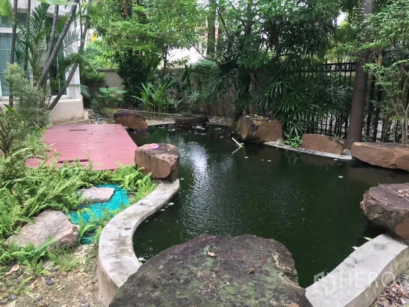 Detached House for rent in Bang Khen, Bangkok - Lush garden with a koi-style pond, boulders and surrounding trees.