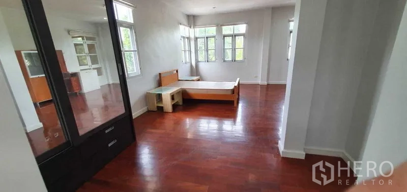 Detached House for rent in Prawet, Bangkok - Generous upstairs bedroom with large windows and built-in closet space.