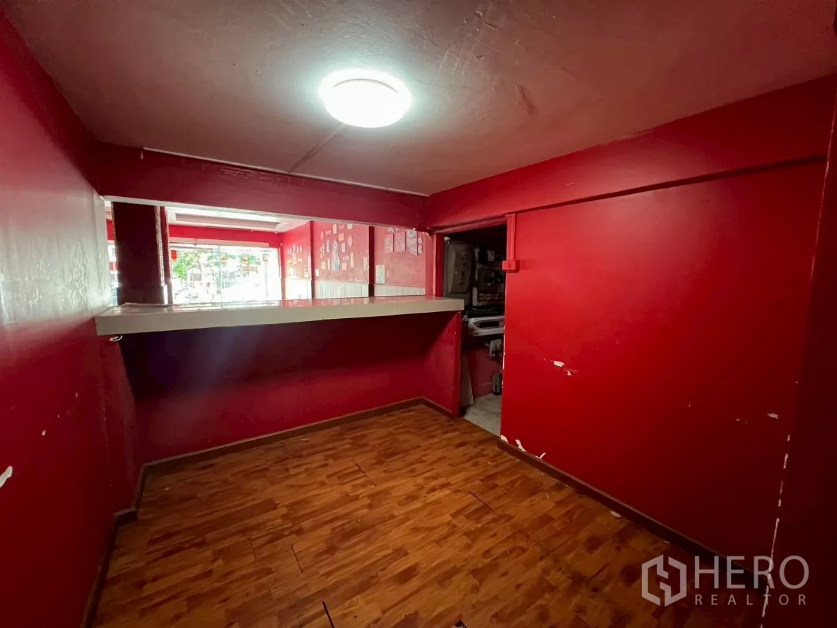 Shophouse for rent in Watthana, Bangkok - Service counter room with a pass-through window facing the shopfront.