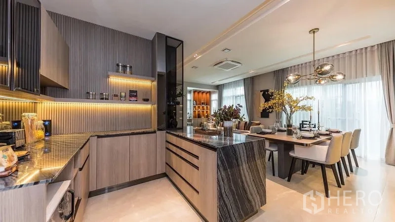 บ้าน ให้เช่าในPrawet, Bangkok - ครัวรูปตัวยูพร้อมไอส์แลนด์หิน ตู้ไม้ และไฟ LED อบอุ่น