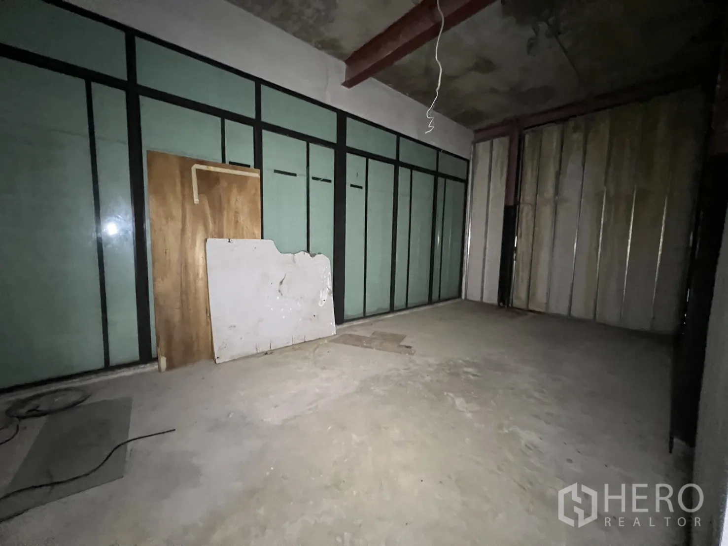 Retail Space for rent in Watthana, Bangkok - Front glass entrance with graffiti and driveway beside power lines.